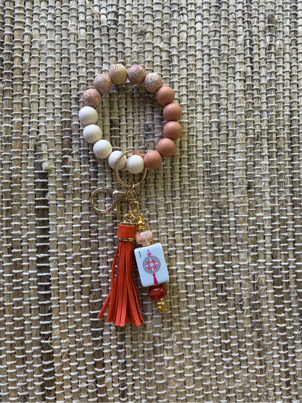 Beaded Wristlet Keychain with Orange Tassel featuring the One Dot Mahjong tile.